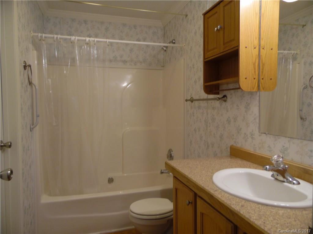 4184 State Rd S-29-304, Unit 2 Lancaster, SC 29720 - Photo 6 of 14 a bathroom with a granite countertop sink toilet and shower