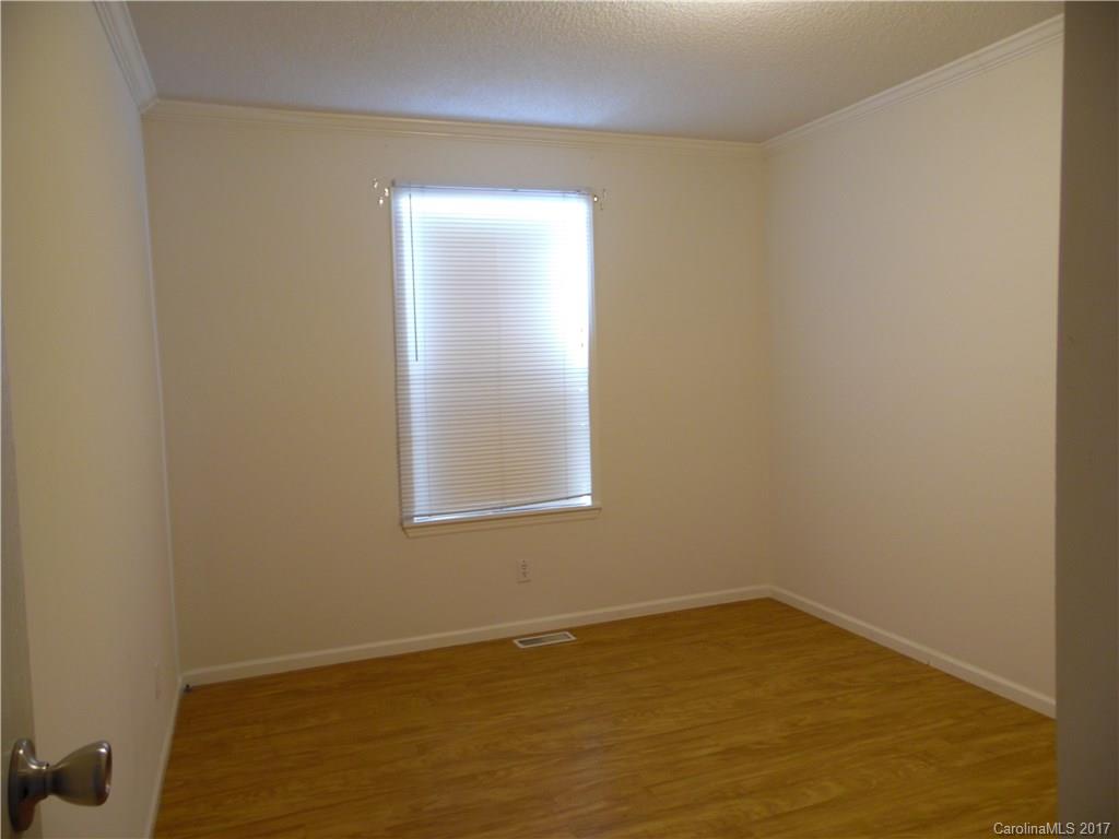4184 State Rd S-29-304, Unit 2 Lancaster, SC 29720 - Photo 7 of 14 a view of an empty room with wooden floor and a window