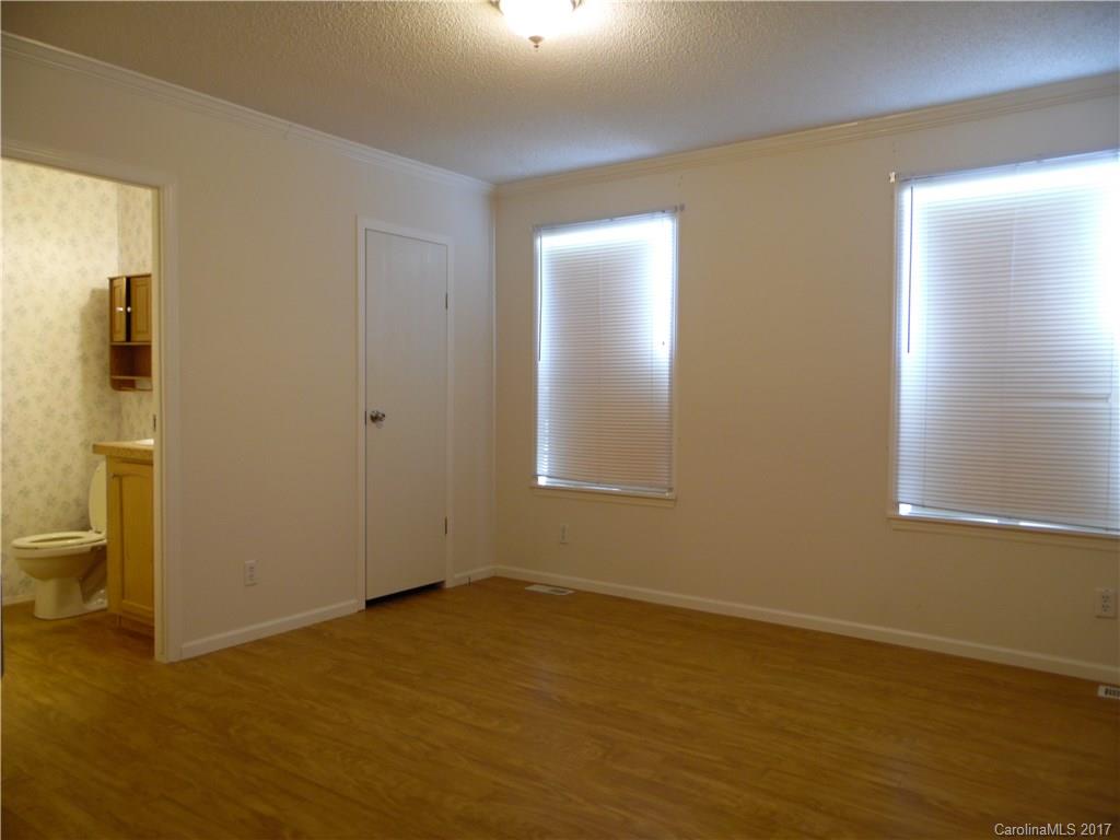 4184 State Rd S-29-304, Unit 2 Lancaster, SC 29720 - Photo 8 of 14 a view of an empty room with wooden floor and a window