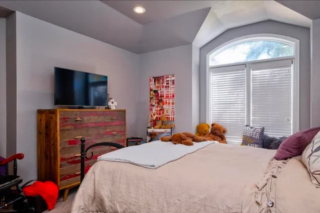 a bedroom with a bed and flat screen tv