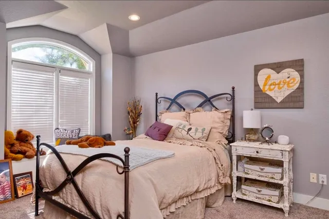 a bedroom with a bed and a table in it