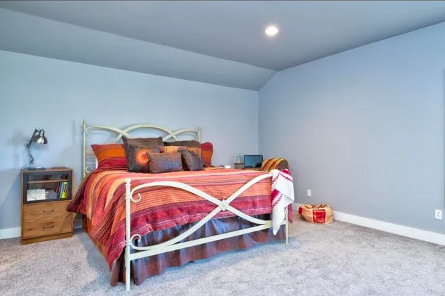 a bedroom with a bed and a lamp