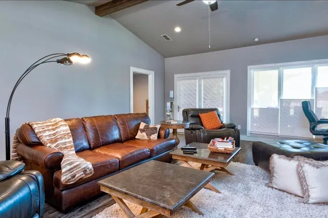 a living room with furniture and wooden floor