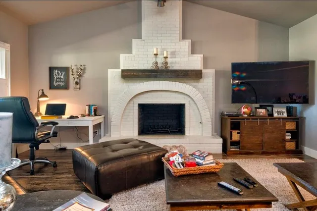 a living room with furniture fireplace and flat screen tv