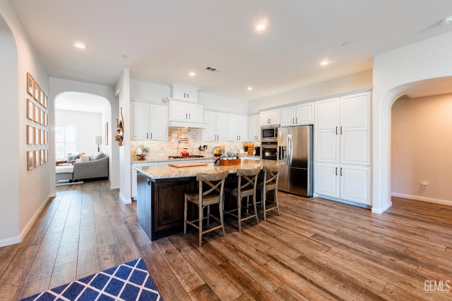 Undisclosed Address Bakersfield, CA 93312 - Photo 11 of 43 a large open kitchen with a table and chairs