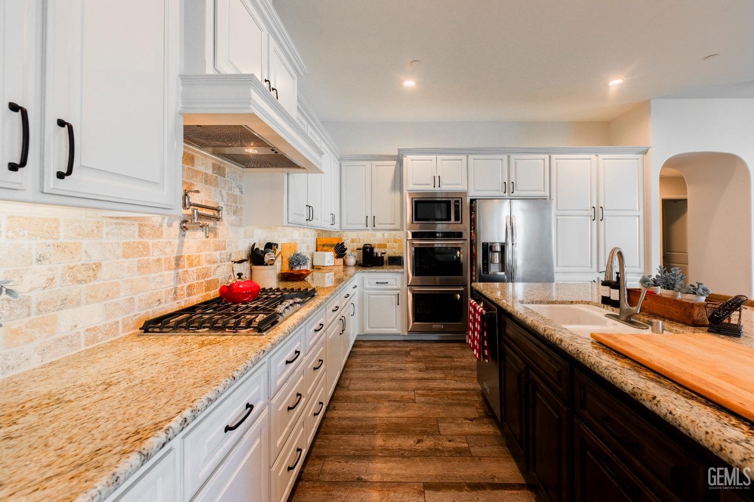Undisclosed Address Bakersfield, CA 93312 - Photo 12 of 43 a kitchen with kitchen island granite countertop a sink counter top space stainless steel appliances and cabinets
