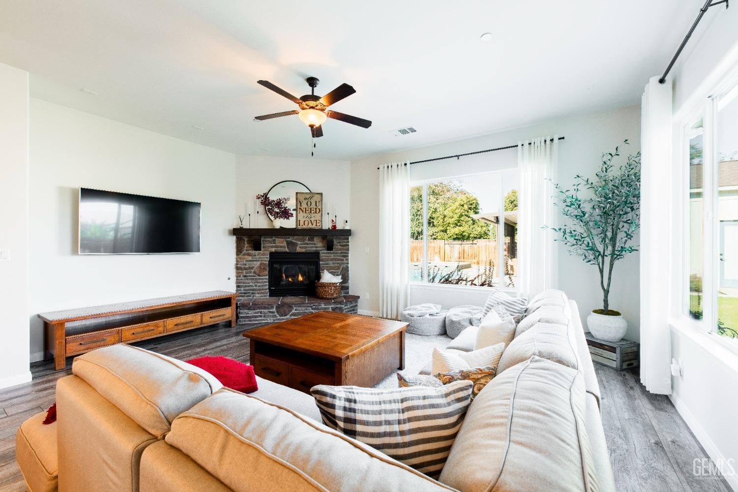 Undisclosed Address Bakersfield, CA 93312 - Photo 16 of 43 a living room with fireplace furniture and a flat screen tv