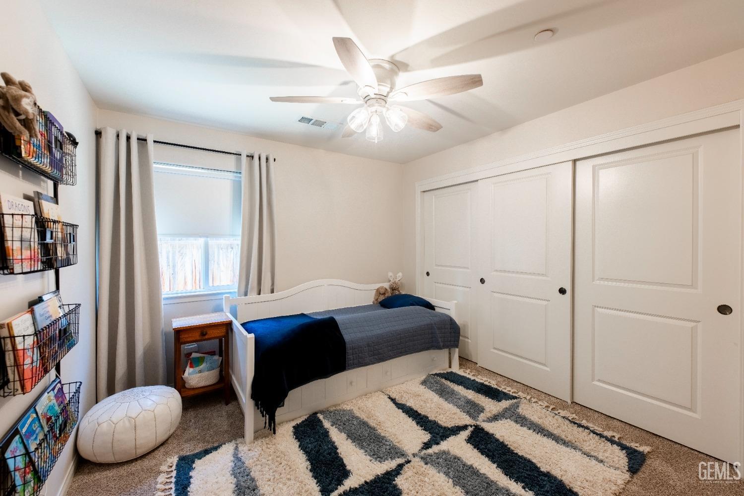 Undisclosed Address Bakersfield, CA 93312 - Photo 18 of 43 a bedroom with a bed and a chandelier