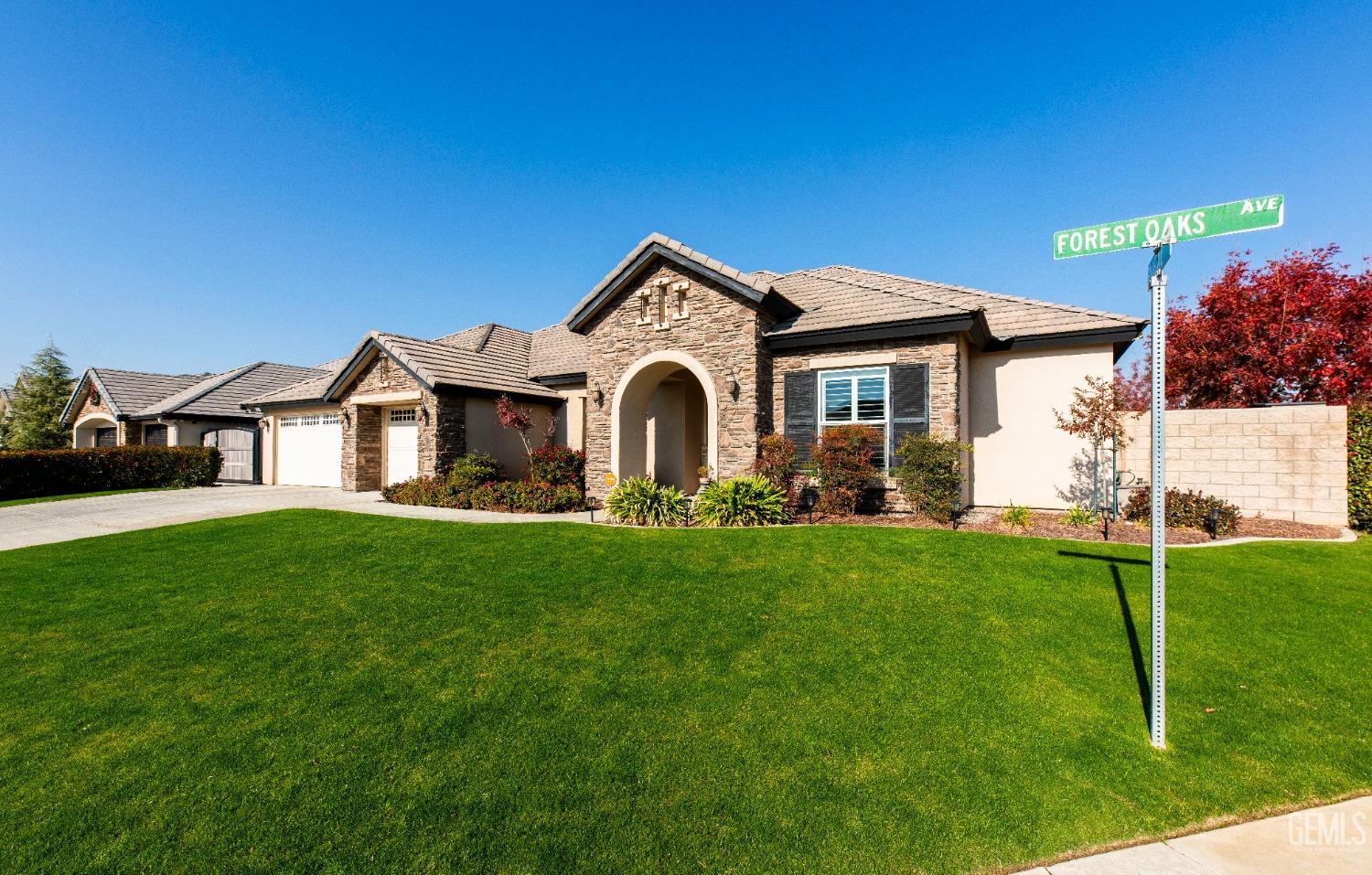 Undisclosed Address Bakersfield, CA 93312 - Photo 2 of 43 a front view of a house with a garden