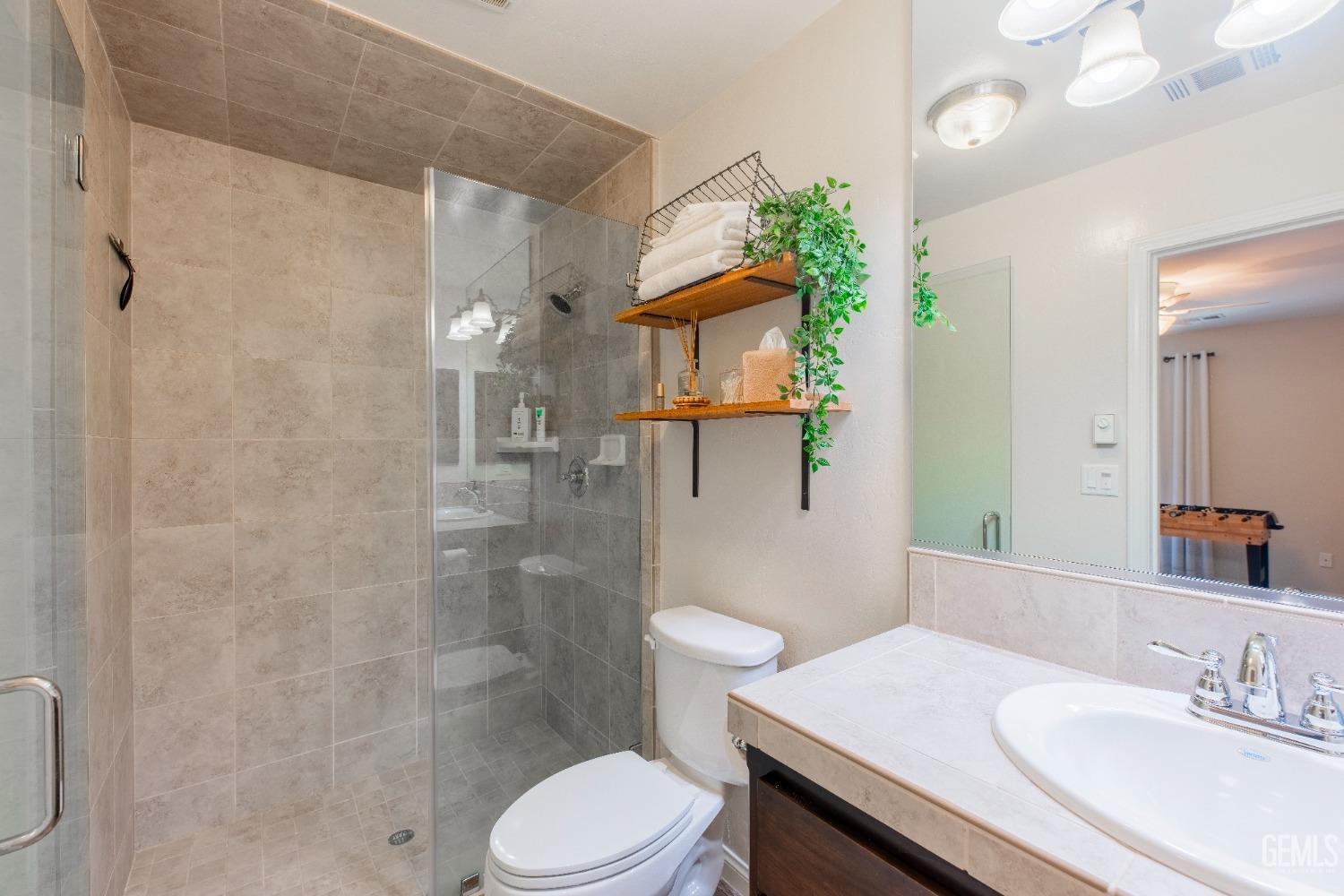 Undisclosed Address Bakersfield, CA 93312 - Photo 21 of 43 a bathroom with a sink toilet and shower