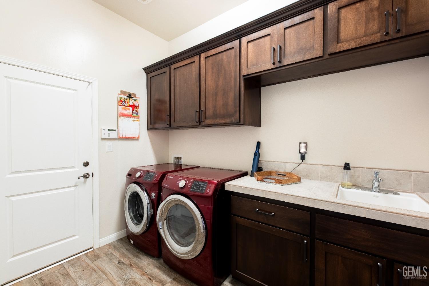 Undisclosed Address Bakersfield, CA 93312 - Photo 25 of 43 a utility room with sink dryer and washer