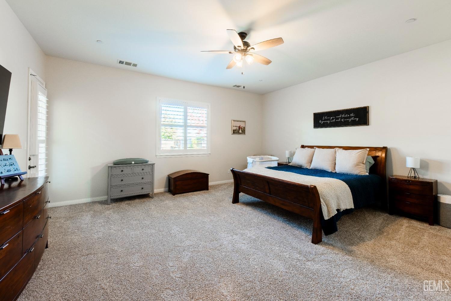 Undisclosed Address Bakersfield, CA 93312 - Photo 26 of 43 a spacious bedroom with a bed and a chandelier