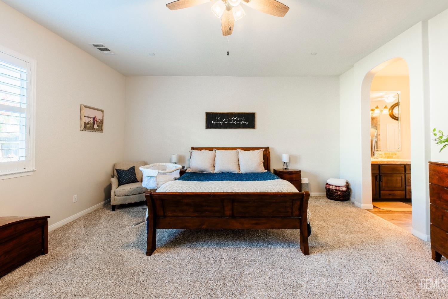 Undisclosed Address Bakersfield, CA 93312 - Photo 27 of 43 a bedroom with a bed and a chandelier