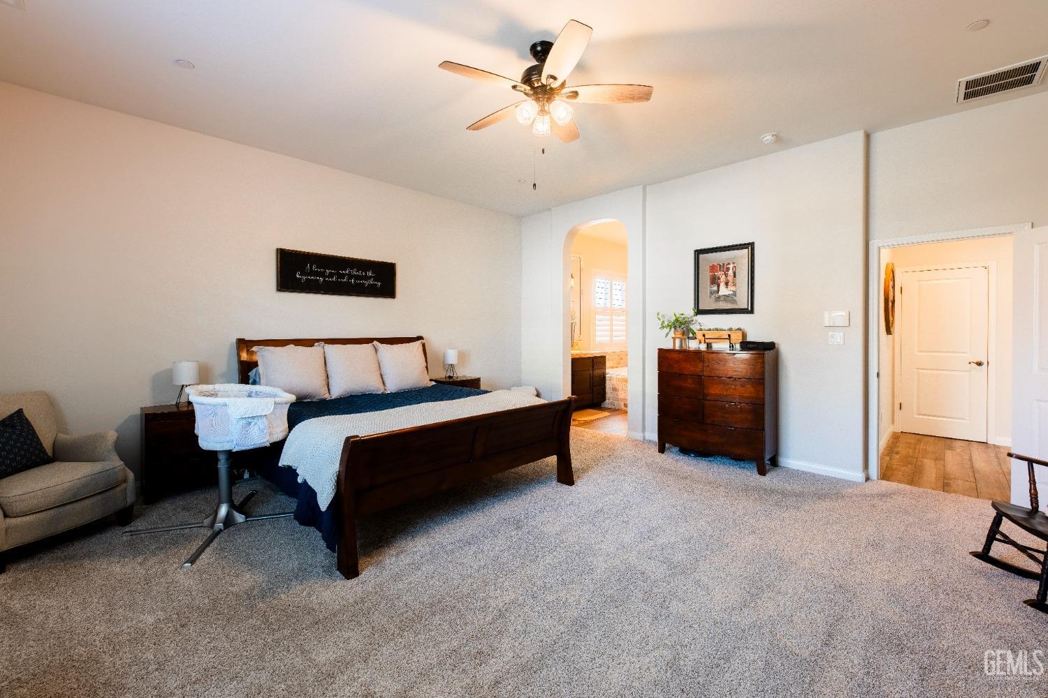 Undisclosed Address Bakersfield, CA 93312 - Photo 28 of 43 a spacious bedroom with a bed and a couch