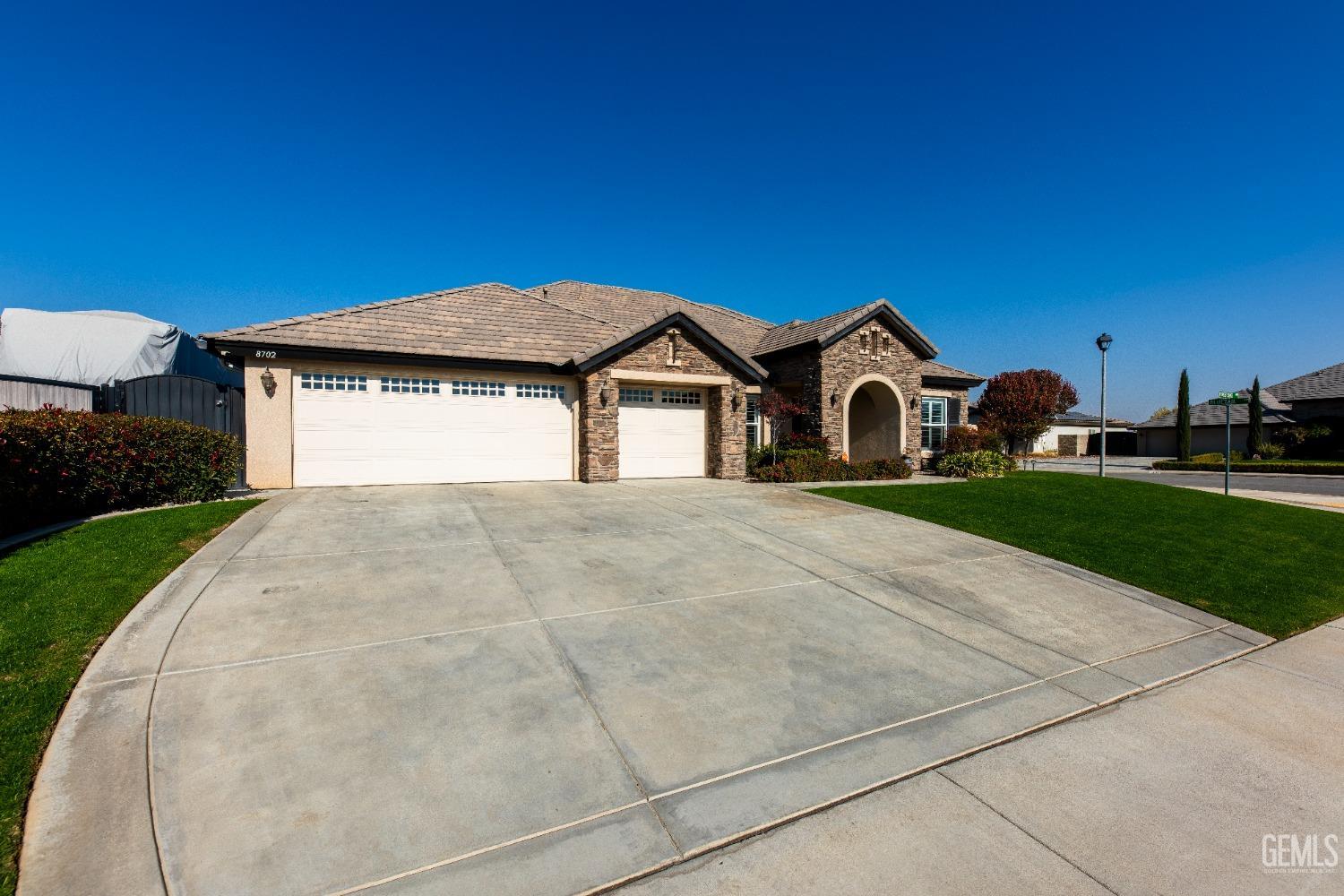 Undisclosed Address Bakersfield, CA 93312 - Photo 3 of 43 a front view of a house with garden