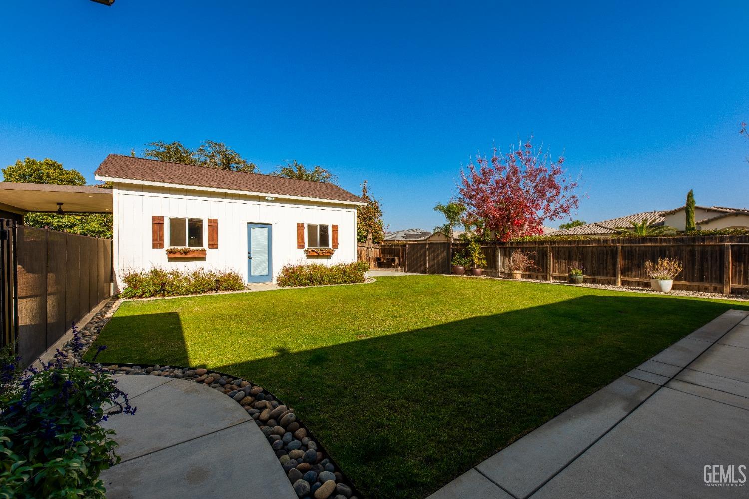 Undisclosed Address Bakersfield, CA 93312 - Photo 33 of 43 a front view of a house with a garden