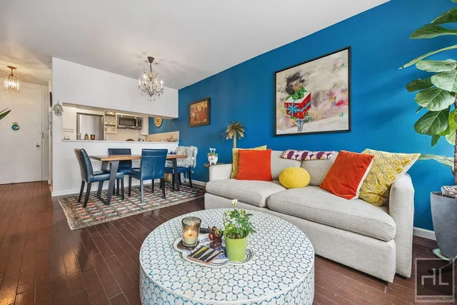 a living room with furniture kitchen view and a table