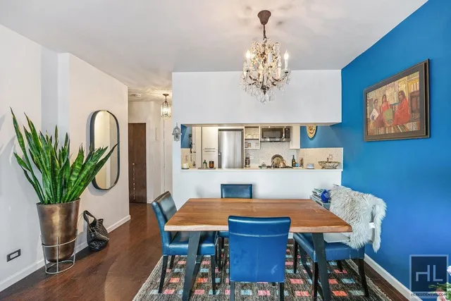 a view of a dining room with furniture wooden floor and chandelier