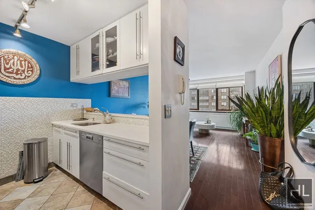 a view of a room with wooden floor and cabinets