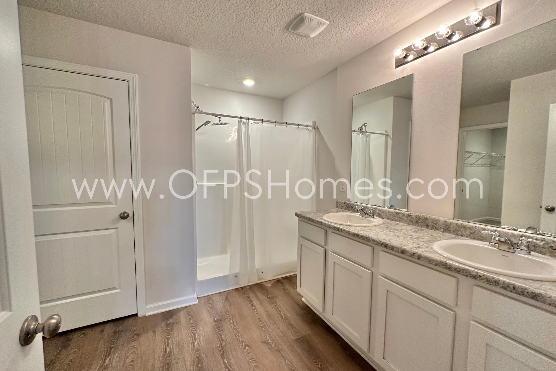 3530 Sugar Maple Lane Crestview, FL 32539 - Photo 15 of 19 a bathroom with a granite countertop sink a mirror and a shower