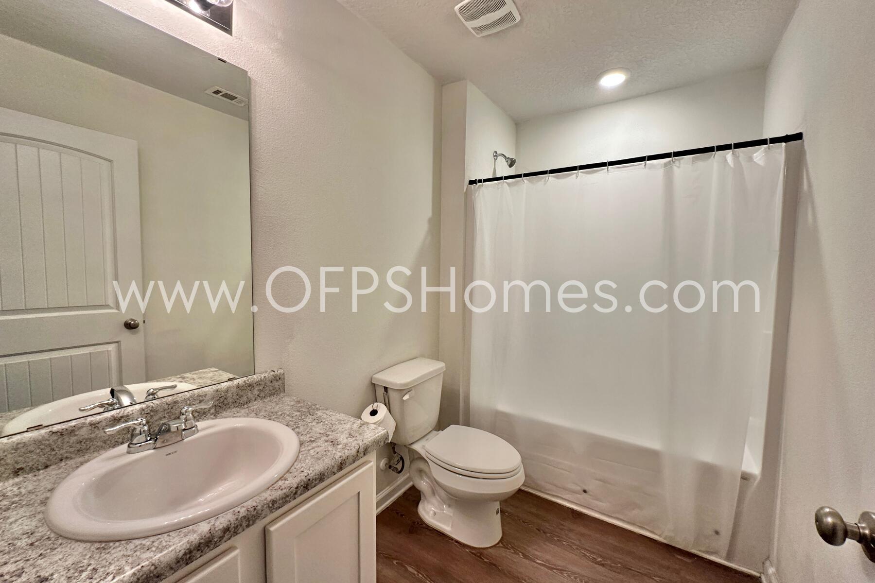 3530 Sugar Maple Lane Crestview, FL 32539 - Photo 6 of 19 a bathroom with a sink a toilet and a mirror
