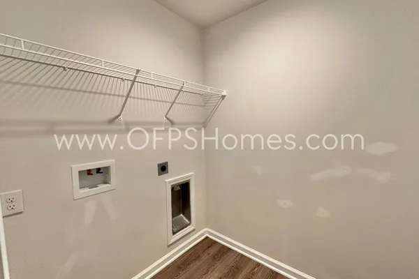 a kitchen with granite countertop a refrigerator and a stove top oven