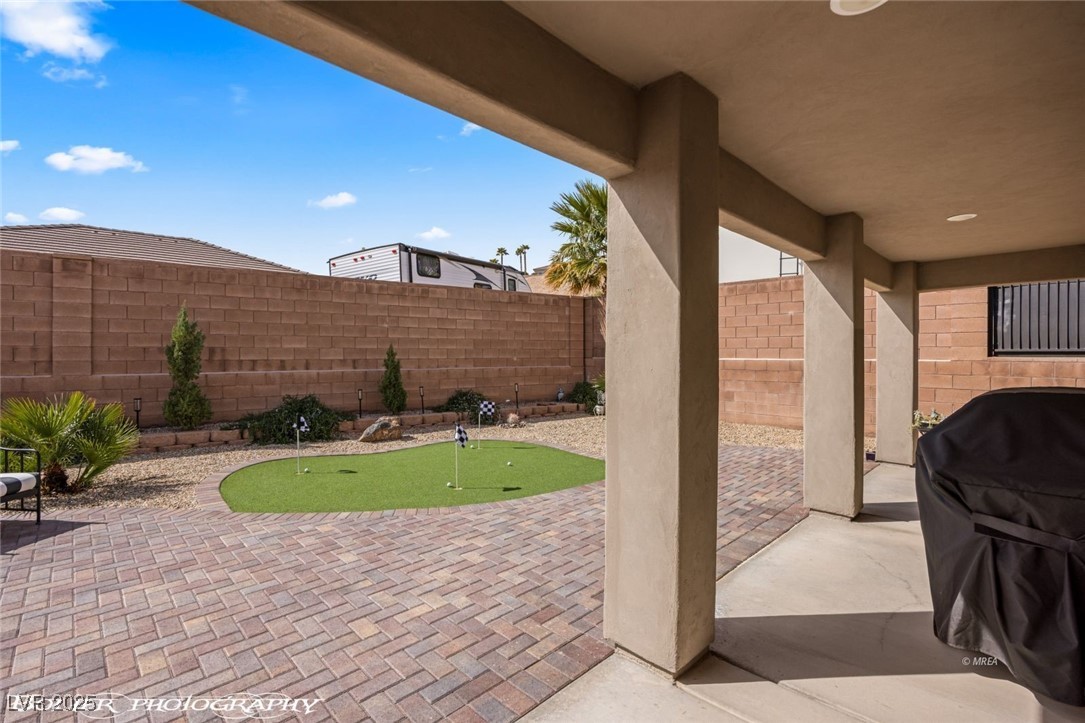 942 Shadow Hawk Ridge Mesquite, NV 89027 - Photo 44 of 67 View of patio / terrace with a putting area, a fenced backyard, and area for grilling