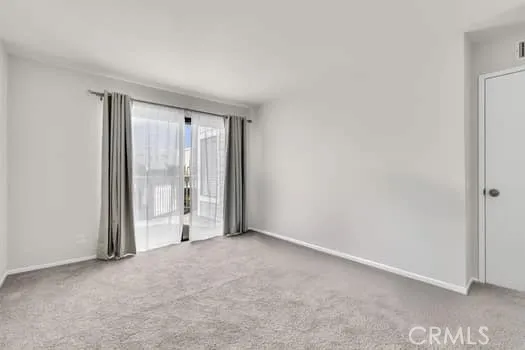 a view of an empty room with glass door