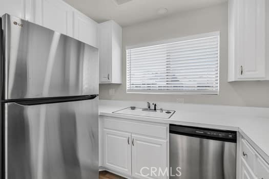 49 Remington Irvine, CA 92620 - Photo 9 of 26 a kitchen with stainless steel appliances a refrigerator sink and cabinets
