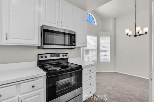 49 Remington Irvine, CA 92620 - Photo 10 of 26 a kitchen with granite countertop white cabinets appliances and a window