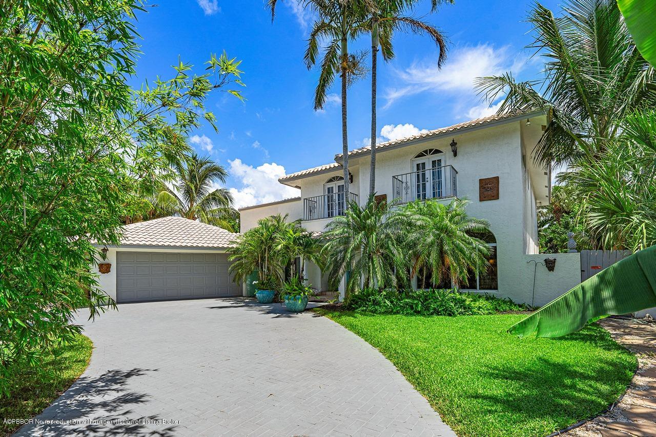 15 East Ocean Avenue Ocean Ridge, FL 33435 - Photo 1 of 31 a front view of a house with a garden