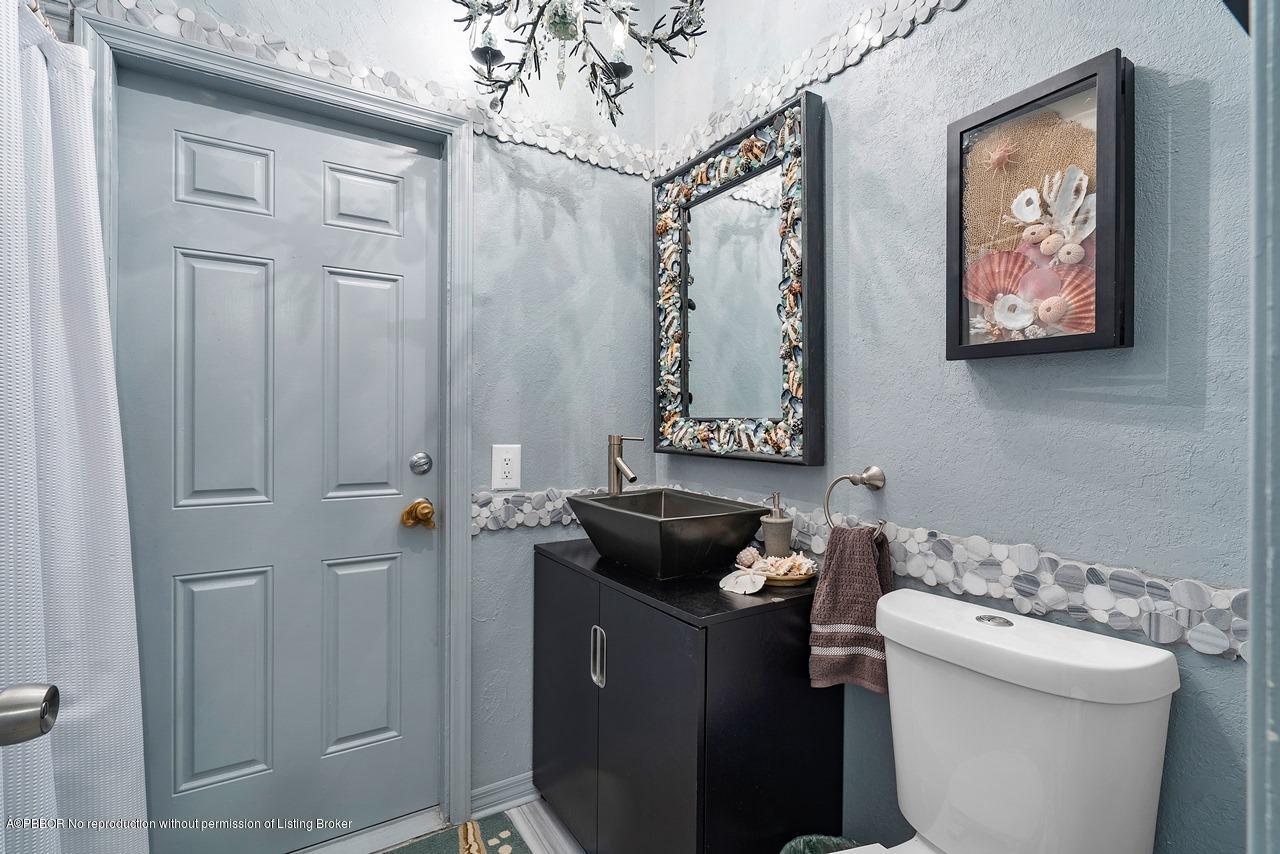 15 East Ocean Avenue Ocean Ridge, FL 33435 - Photo 15 of 31 a bathroom with a sink toilet and vanity