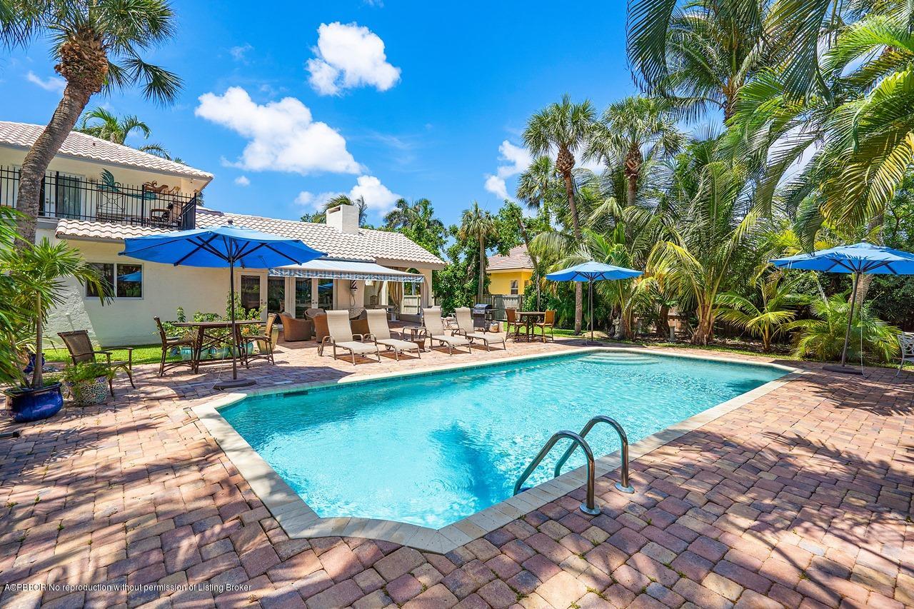 15 East Ocean Avenue Ocean Ridge, FL 33435 - Photo 23 of 31 a view of a swimming pool with lounge chairs in patio