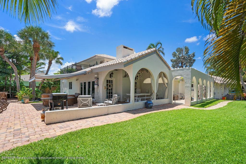 15 East Ocean Avenue Ocean Ridge, FL 33435 - Photo 28 of 31 a front view of a house with swimming pool and furniture