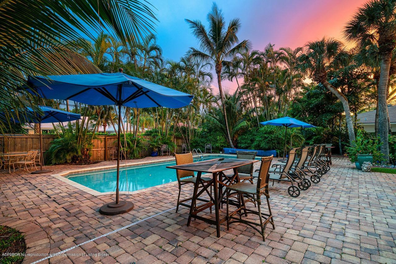 15 East Ocean Avenue Ocean Ridge, FL 33435 - Photo 6 of 31 an outdoor space with furniture and umbrella