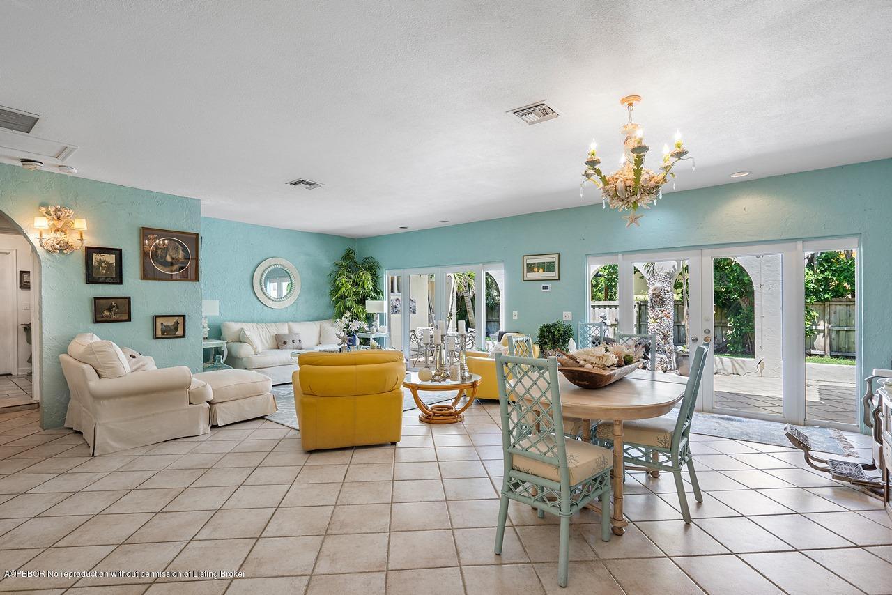 15 East Ocean Avenue Ocean Ridge, FL 33435 - Photo 8 of 31 a living room with furniture and a chandelier