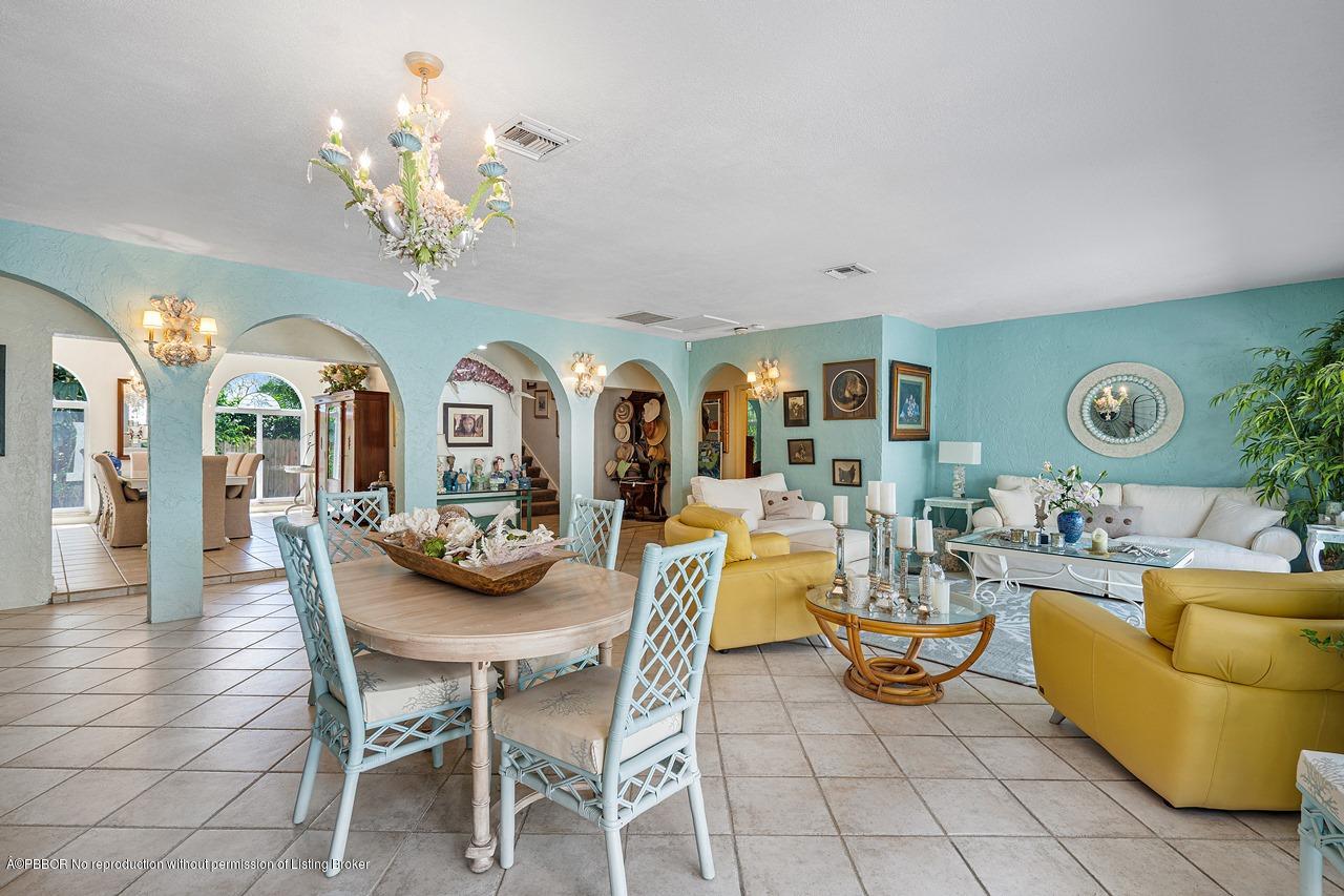 15 East Ocean Avenue Ocean Ridge, FL 33435 - Photo 9 of 31 a view of a dining room with furniture a chandelier and wooden floor