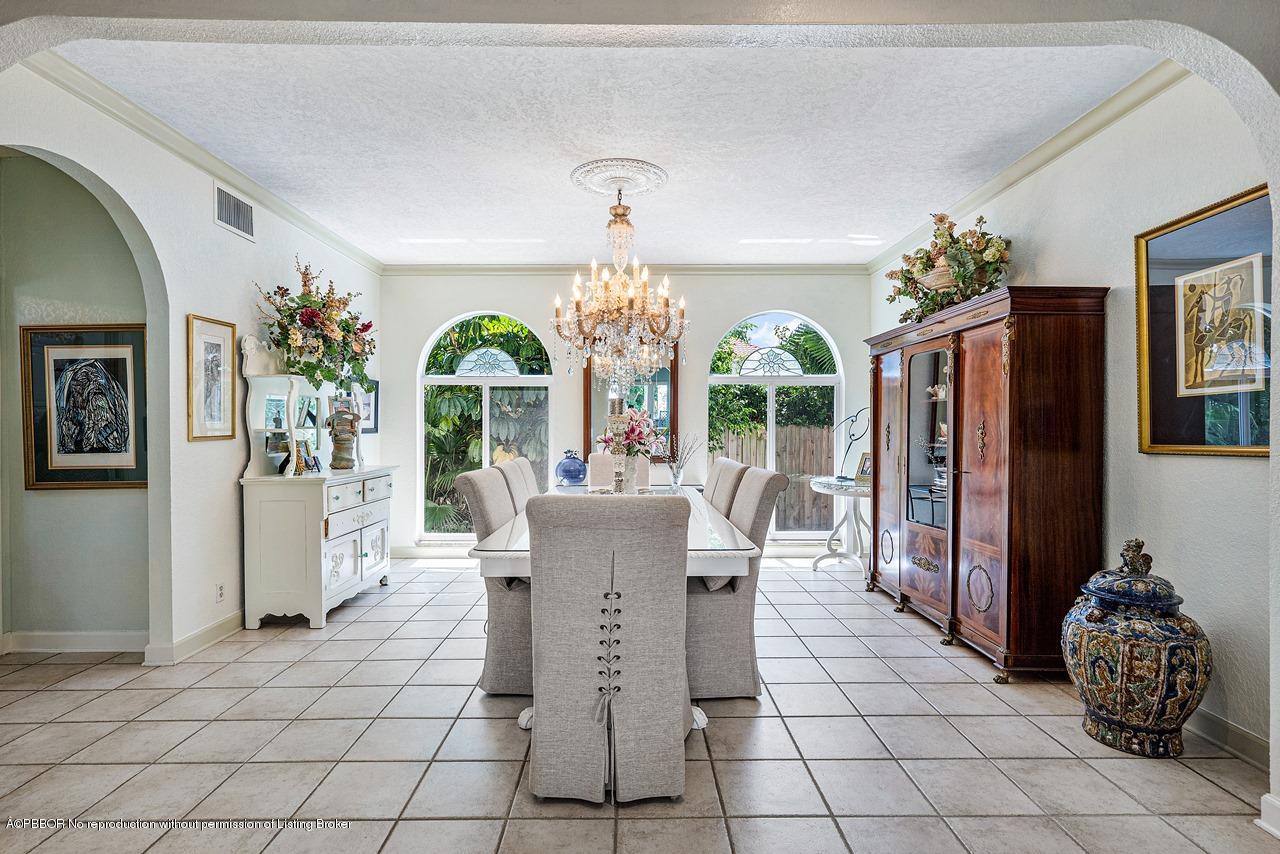 15 East Ocean Avenue Ocean Ridge, FL 33435 - Photo 10 of 31 a view of a dining room with furniture wooden floor and chandelier