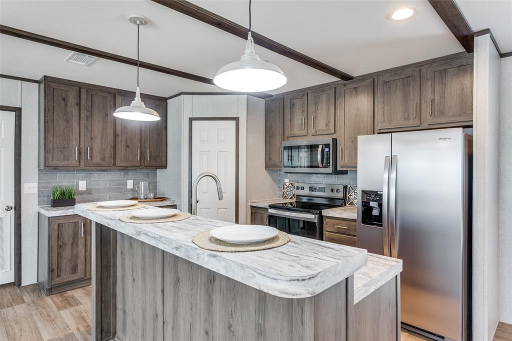 175 Cedar Drive Azle, TX 76020 - Photo 1 of 25 a kitchen with granite countertop a sink stove and refrigerator