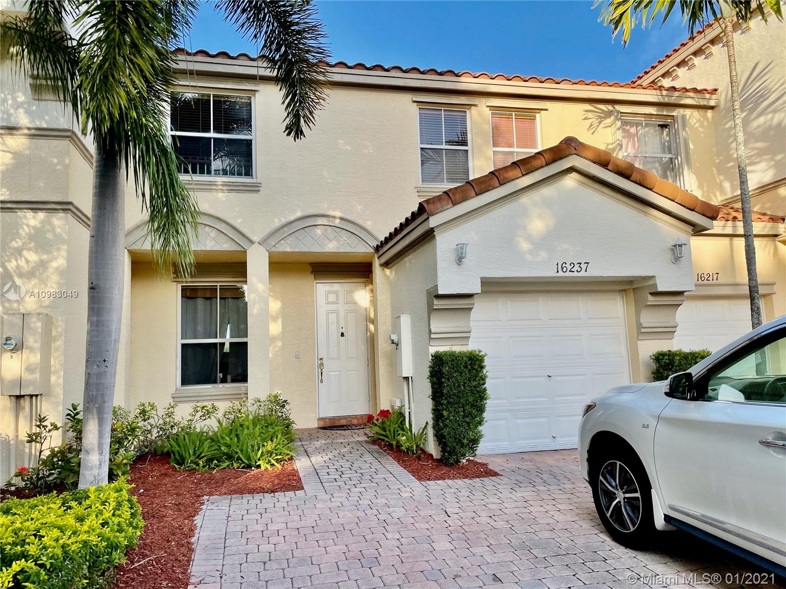 16237 Southwest 48th Street Miramar, FL 33027 - Photo 1 of 28 a view of a car parked in front of a white house