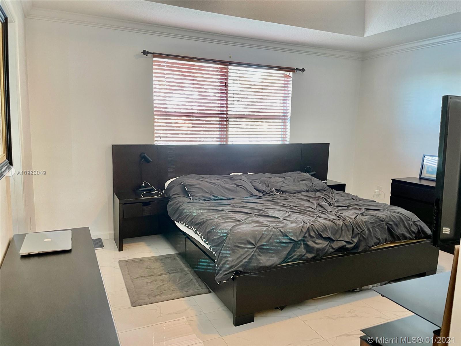 16237 Southwest 48th Street Miramar, FL 33027 - Photo 11 of 28 a bedroom with a bed and a window