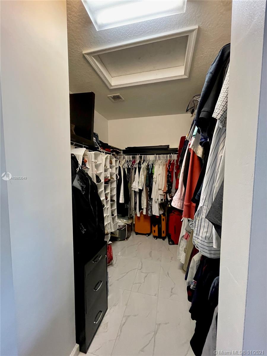 16237 Southwest 48th Street Miramar, FL 33027 - Photo 12 of 28 a view of walk in closet with clothes and shoes