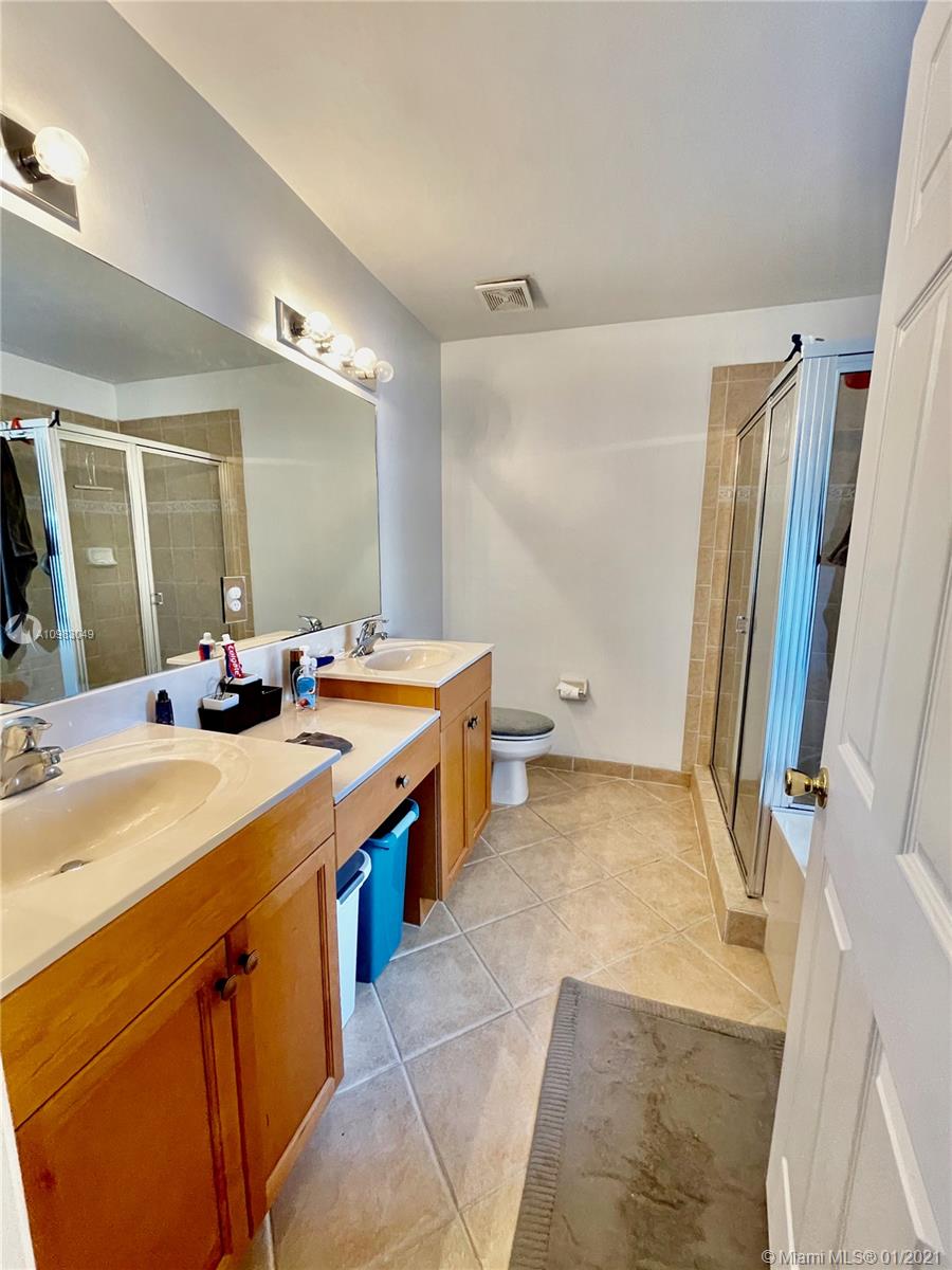 16237 Southwest 48th Street Miramar, FL 33027 - Photo 14 of 28 a bathroom with a double vanity sink a mirror and a shower