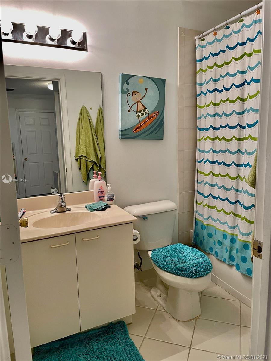 16237 Southwest 48th Street Miramar, FL 33027 - Photo 19 of 28 a bathroom with a sink toilet and a mirror