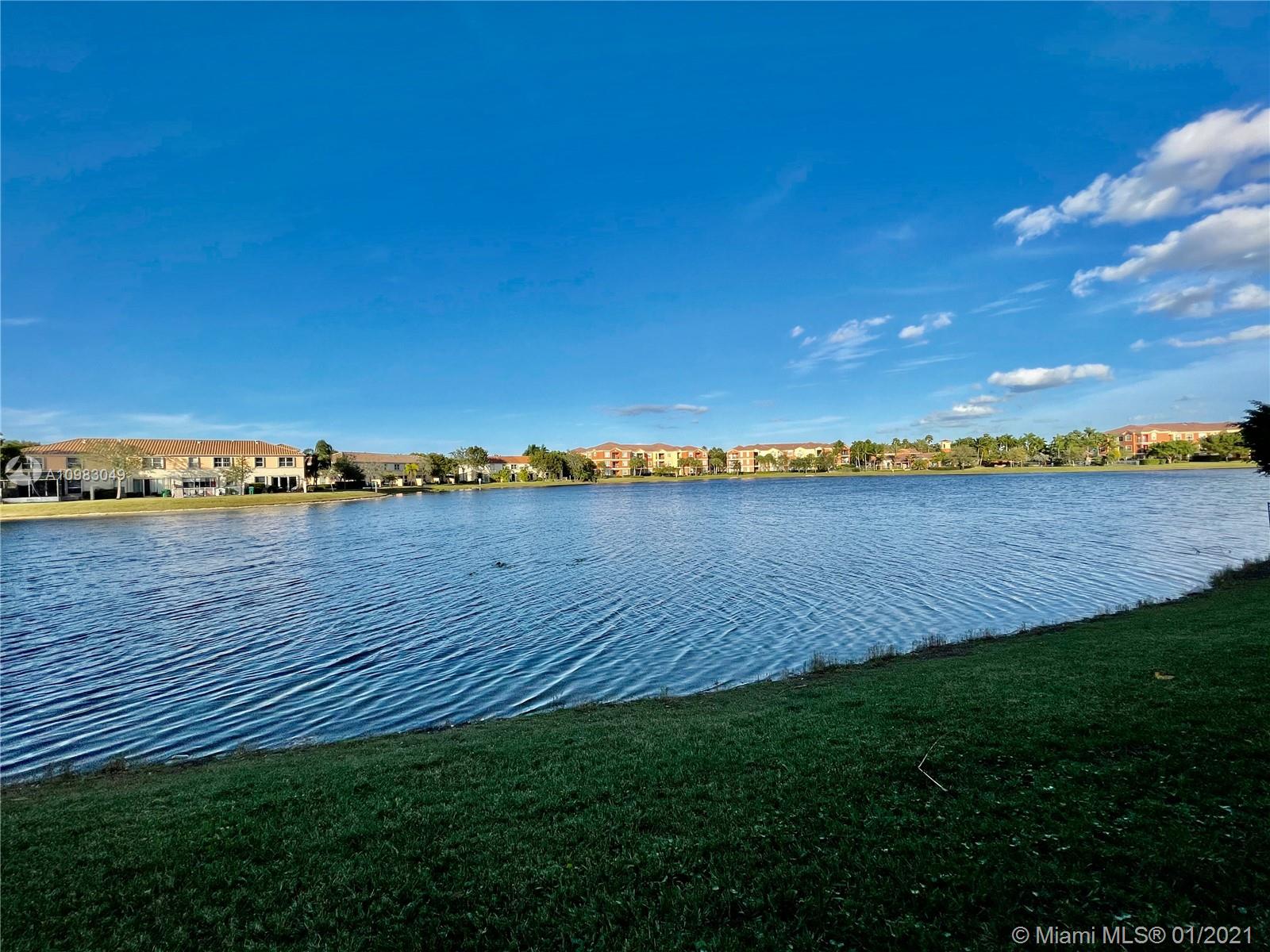 16237 Southwest 48th Street Miramar, FL 33027 - Photo 27 of 28 a view of a lake with houses in the back