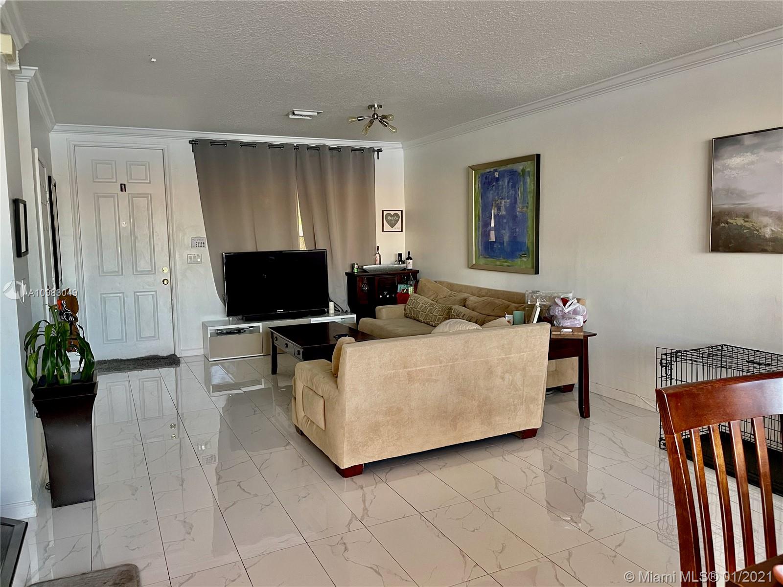 16237 Southwest 48th Street Miramar, FL 33027 - Photo 4 of 28 a living room with furniture and a flat screen tv