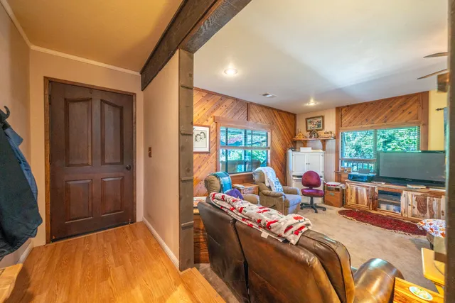 a living room with furniture and a chandelier