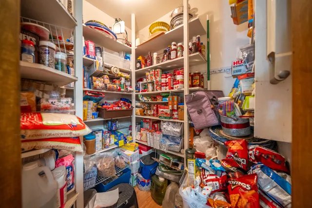 a bed sitting in a spacious bedroom next to a window