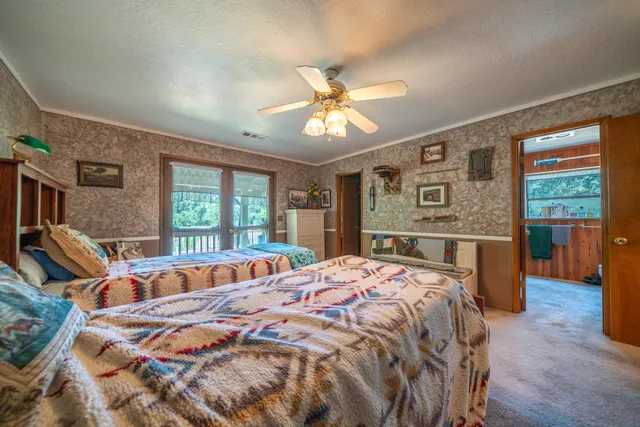 a bathroom with a granite countertop sink a mirror and a shower