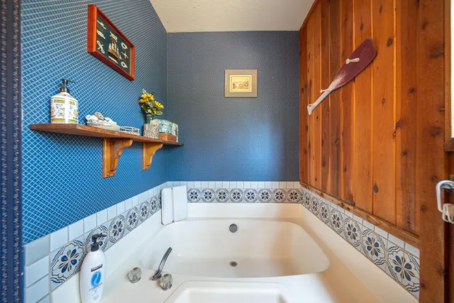 a view of a chair and table in backyard of the house